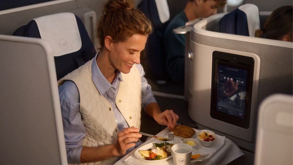 Woman enjoying a meal in Lufthansa business class